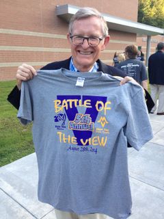 President Gee holds up a Battle of the View T-shirt.