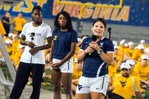 Women's soccer coach Nikki Brown speaks to students.