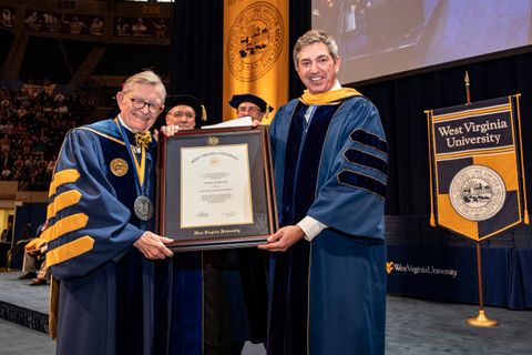 Stavros Lambrinidis receives framed degree from President Gee as Greg Dunaway and Scott Wayne look on.