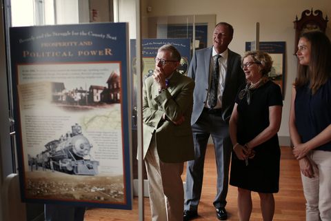 President Gee and members of the WVU group view displays about Beverly's history.