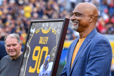Darryl Talley with a framed No. 90 jersey