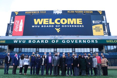 Board of Governors members pose for a group photo on Mountaineer Field.