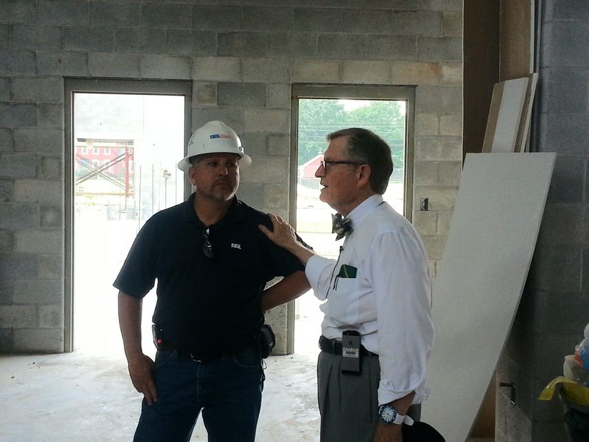 Mike Wells and President Gee inside new school