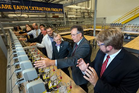 President Gee and other tour members interact with laboratory equipment