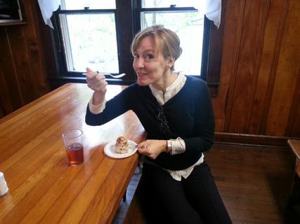 Dr. Lisa DiBartolomeo eats a cinnamon roll