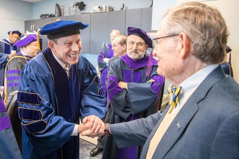 Robert Fitzsimmons shakes hands with President Gee 
